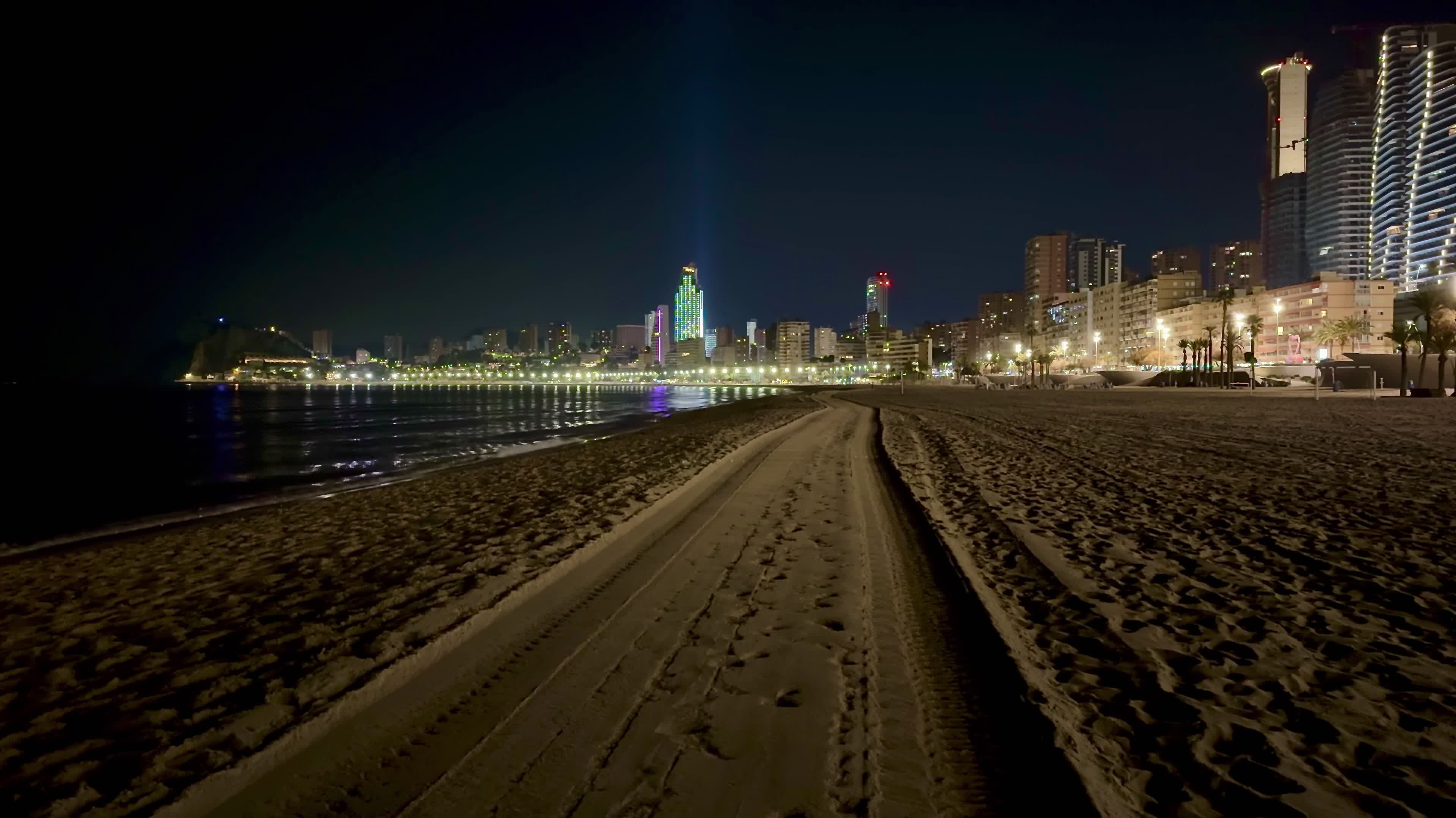 Bright artificial lights illuminate a Florida beach during sea turtle nesting season, illustrating how beachfront lighting can disorient nesting sea turtles and hatchlings.